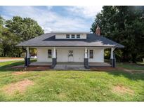 White house with a front porch, gray columns, and a dark gray roof at 328 Miller Ave, Statesville, NC 28677