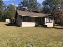 Pink house exterior with brown roof and lawn at 624 Hart St, Heath Springs, SC 29058