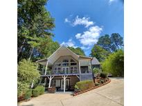 Two-story house with large windows, deck, and wooded setting at 3645 Lake Bluff Dr, Sherrills Ford, NC 28763