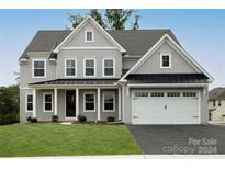 Two story house with gray siding, white trim, and a black metal roof at 11318 James Coy Rd # Devonshire, Davidson, NC 28036