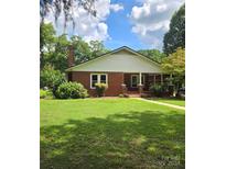 Brick ranch house with covered porch and landscaped yard at 4210 Old Beatty Ford Rd, China Grove, NC 28023