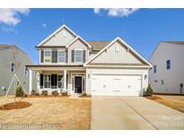 Two-story home with gray siding, white trim, and a two-car garage at 8631 Frank Grier Rd # 6, Charlotte, NC 28215
