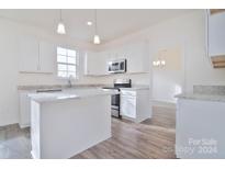 Modern kitchen with white cabinets, granite countertops and island at 105 Megby Trl, Statesville, NC 28677
