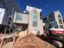 Modern home exterior with brick and light-colored siding, under construction at 719 Charles Ave, Charlotte, NC 28205