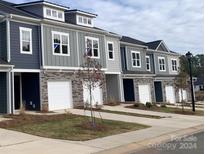 Modern townhouses with gray siding and white garage doors at 2773 Ruby Mill Dr # 41, Gastonia, NC 28056