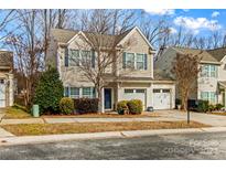 Tan two-story house with a two-car garage and landscaping at 105 Collenton Ln, Mooresville, NC 28115