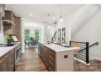 Modern kitchen with island and stainless steel appliances at 1424 Hamilton St # 12, Charlotte, NC 28206