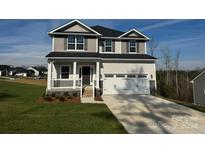 Two-story house with gray and beige siding, a two-car garage, and a front porch at 103 High Rock Ct # 11, Statesville, NC 28677