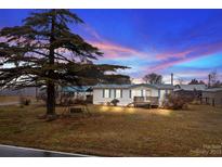 Single wide mobile home with front porch and large tree at 3430 Potneck Rd, Salisbury, NC 28147