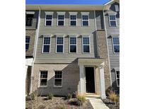 Two-story townhome with neutral siding and multiple windows at 4225 S New Hope Rd # 9, Cramerton, NC 28032