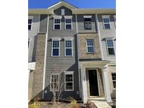 Three-story townhome with gray siding and brick at 4223 S New Hope Rd # 8, Cramerton, NC 28032