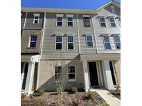 Three-story townhome with gray siding at 4229 S New Hope Rd # 11, Cramerton, NC 28032