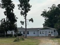 Ranch style home with light blue exterior, and a green trim at 3923 Old Pageland Monroe Rd, Monroe, NC 28112