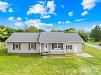 Ranch-style home with a spacious yard and detached garage at 215 Bethesda Rd, Statesville, NC 28677