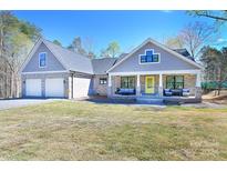 Charming craftsman style home with a two-car garage and inviting front porch at 317 Gardner Point Dr, Stony Point, NC 28678