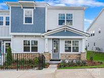 Two-story townhome with gray siding and stone accents at 8915 Nettleton Ave, Charlotte, NC 28215