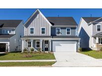 Two-story home with gray and blue siding, white garage door, and landscaping at 113 Ryan Ln, Mooresville, NC 28115