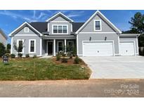 Two-story house with gray siding, three-car garage, and landscaping at 139 Dabbling Duck Cir, Mooresville, NC 28117