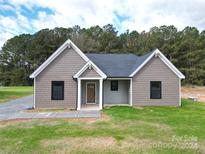 Gray vinyl-sided house with a gray roof and a covered porch at 9617 Hwy 52 N None # 3, Wadesboro, NC 28170
