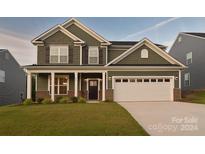 Two story home with green siding and white garage door at 108 Megby Trl, Statesville, NC 28677