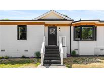 Renovated home with white brick and black door at 19627 Smith Cir, Cornelius, NC 28031