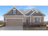 Curb appeal abounds in this charming craftsman style home, featuring a two-car garage at 164 Sari St, Troutman, NC 28166