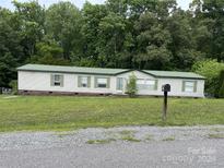 Single-wide mobile home with green metal roof at 145 Crown Ct, Kings Mountain, NC 28086