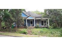 Blue Victorian style house with front porch needs some repairs at 118 Summit Ave, Albemarle, NC 28001