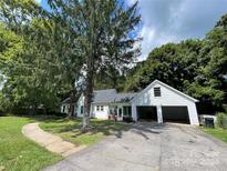 Charming single-story home with attached garage and well-maintained lawn at 3130 Faith Rd, Salisbury, NC 28146