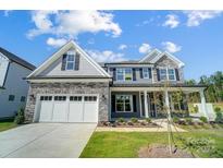 Two story house with gray siding and stone accents at 2004 Cedar Falls Dr # 4, Waxhaw, NC 28173