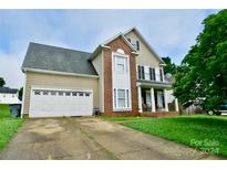 Two-story house with a two-car garage and brick facade at 9841 Baxter Caldwell Dr, Charlotte, NC 28213