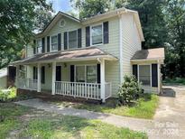 Two-story house with light green siding and a front porch at 2819 Royal Ridge Ln, Charlotte, NC 28212