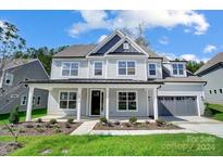 Two-story house with gray siding, a covered porch, and a two-car garage at 2016 Cedar Falls Dr # 7, Waxhaw, NC 28173
