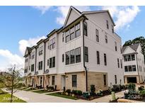 Modern three-story townhouses with white siding at 512 Lockwood Creek Dr # 29, Charlotte, NC 28208