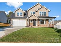 Two story home with a two-car garage and landscaped yard at 4444 Triumph Sw Dr, Concord, NC 28027