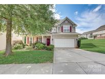 Two story house with landscaping and driveway at 8714 Brideswell Ln, Charlotte, NC 28278