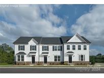 Three-unit townhome exterior with white siding and stone accents at 1979 Tupelo Grove Ln, Gastonia, NC 28054