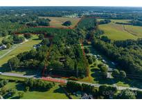 Aerial view of large lot with mature trees, ideal for development at 2210 Goldmine Rd, Monroe, NC 28110