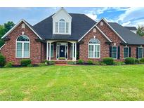 Brick home with landscaped yard and large windows at 115 Anson Dr, China Grove, NC 28023