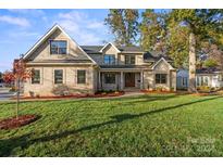Two-story brick home with a landscaped lawn at 101 Mcalway Rd, Charlotte, NC 28211