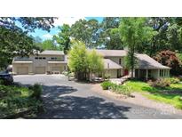 House exterior with a three car garage and private driveway at 9625 Surface Hill Rd, Mint Hill, NC 28227