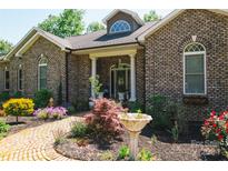 Brick ranch home with landscaped front yard and brick walkway at 4642 King Crowder Dr, Gastonia, NC 28052