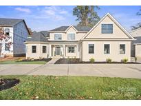 Two-story house with beige exterior and a front porch at 4023 Randolph Rd, Charlotte, NC 28211