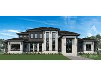 Two-story home with dark siding, white accents, and a three-car garage at 628 Wisteria Vines Trl # 6, Fort Mill, SC 29708