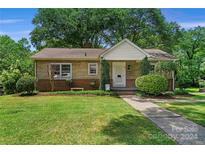 Brick ranch home with a well-manicured lawn and walkway at 810 Hampton St, Shelby, NC 28152