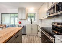 Modern kitchen with stainless steel appliances and butcher block island at 925 Henkel Rd, Statesville, NC 28677