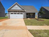 Craftsman style home with a two car garage and landscaping at 126 Brixham Loop, Troutman, NC 28166