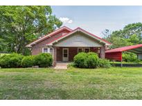 Brick house with red metal roof and carport at 2491 Highway 274 Hwy, Cherryville, NC 28021