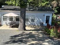 Cute bungalow with patio furniture and a tree in front at 108 Meadowview Cir, New London, NC 28127