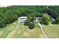 Aerial view of house, pool, and expansive grounds at 5610 Golden Pond Dr, Indian Trail, NC 28079